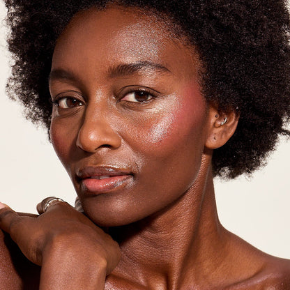 DEEPCHERRYBLUSH-1 Deep skin woman with deep cherry blush against a plain background