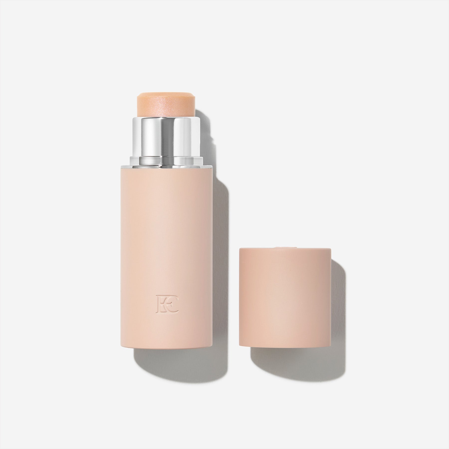 A pink, cylindrical stick with a beige top, in a minimalist design.